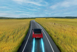 red-car-driving-through-wheat-field